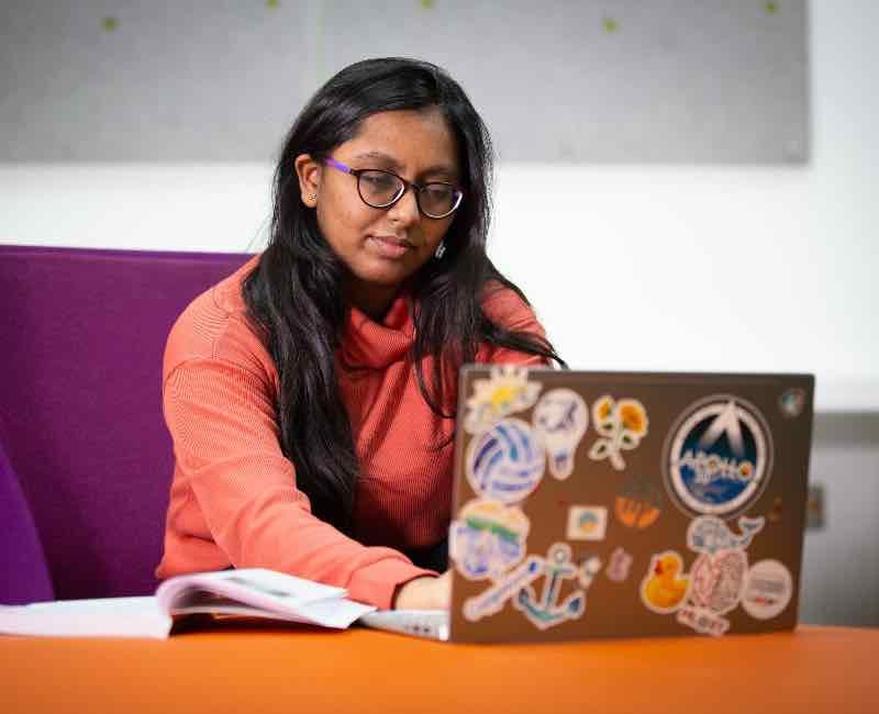 AI student working on a laptop computer